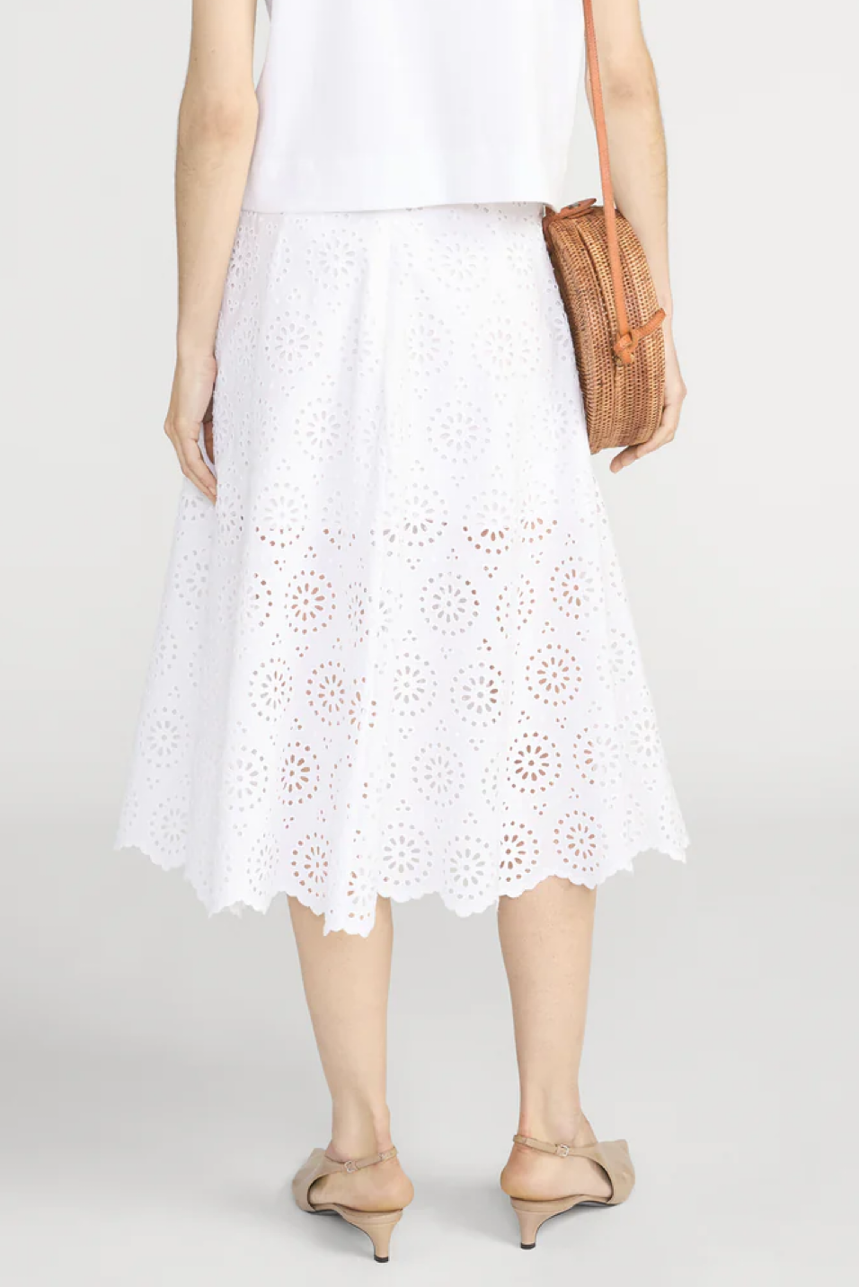 Person wearing a white skirt 