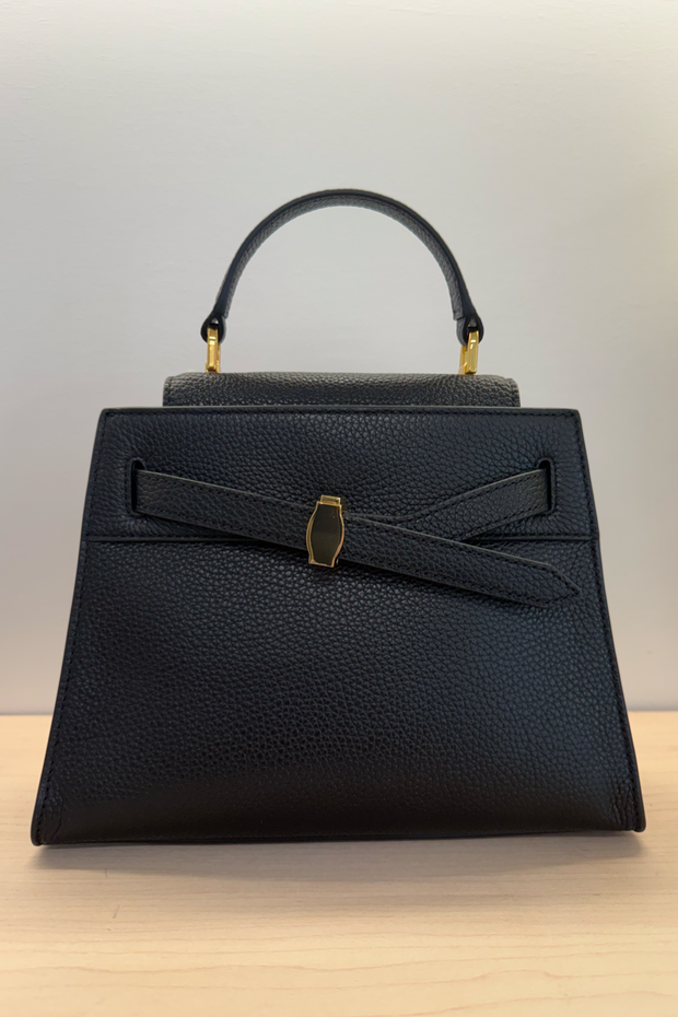 Image of a black pebbled leather top handle bag with gold hardware