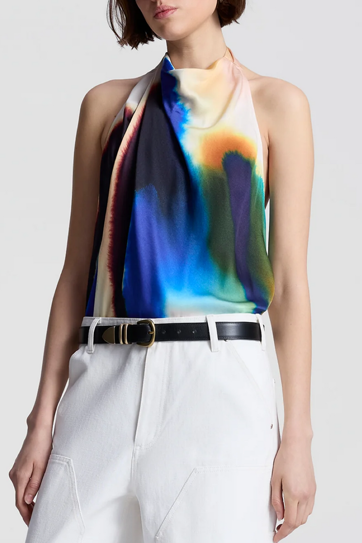 Woman wearing a colorful halter top with a white background