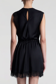 Black dress with lace details on a white background