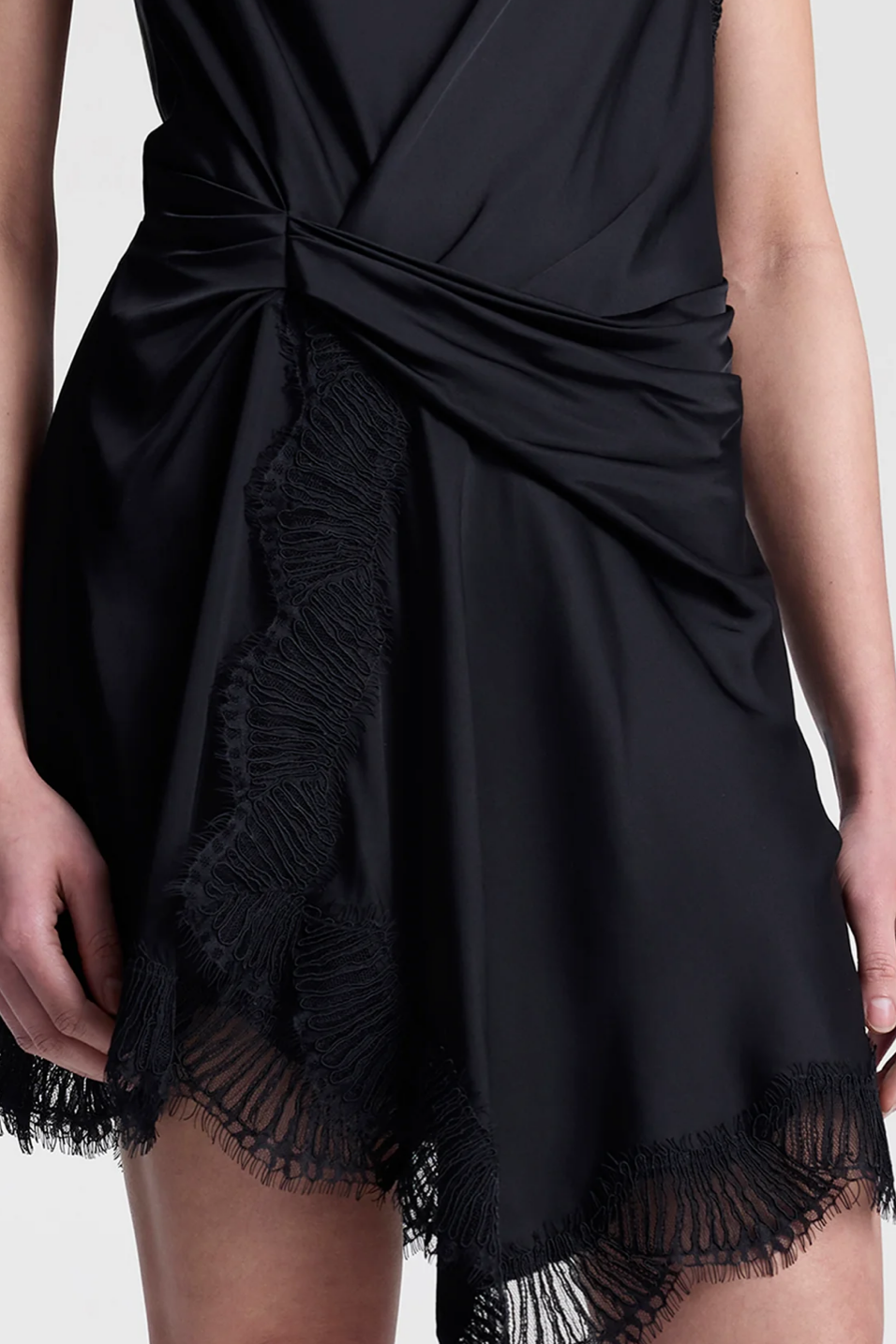 Black dress with frayed hem on a white background