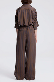 Person wearing a brown striped outfit on a white background