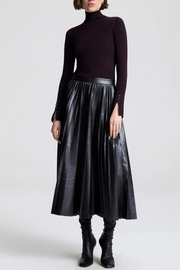 Image of model wearing a vegan pleated leather skirt in deepest brown