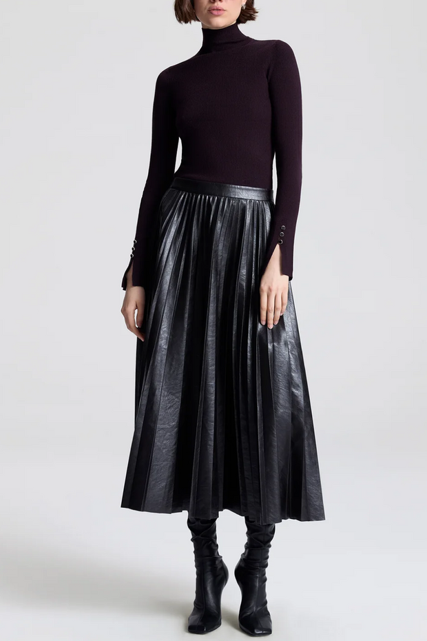 Image of model wearing a vegan pleated leather skirt in deepest brown