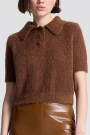 Brown fuzzy short-sleeve top worn by a person on a white background
