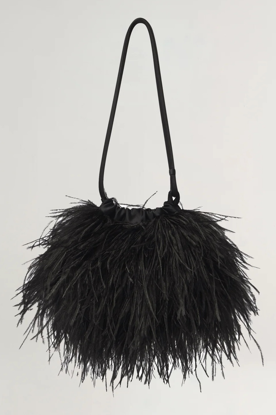 Black feathered handbag on a light gray background
