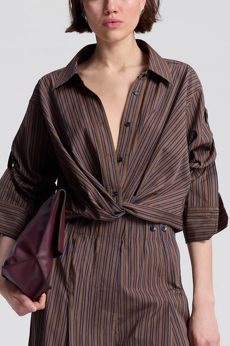 Person wearing a brown striped outfit with a plain background