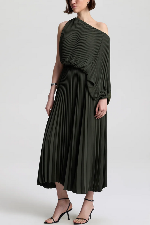 Woman wearing a green pleated one-shoulder dress on a white background