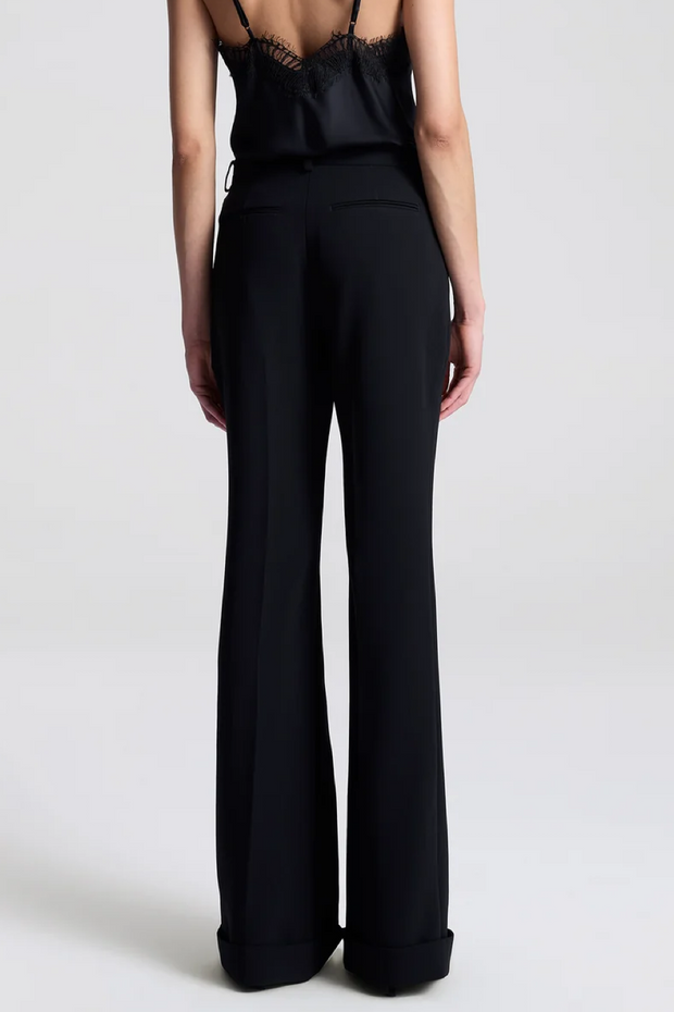 Person wearing a black jumpsuit on a white background