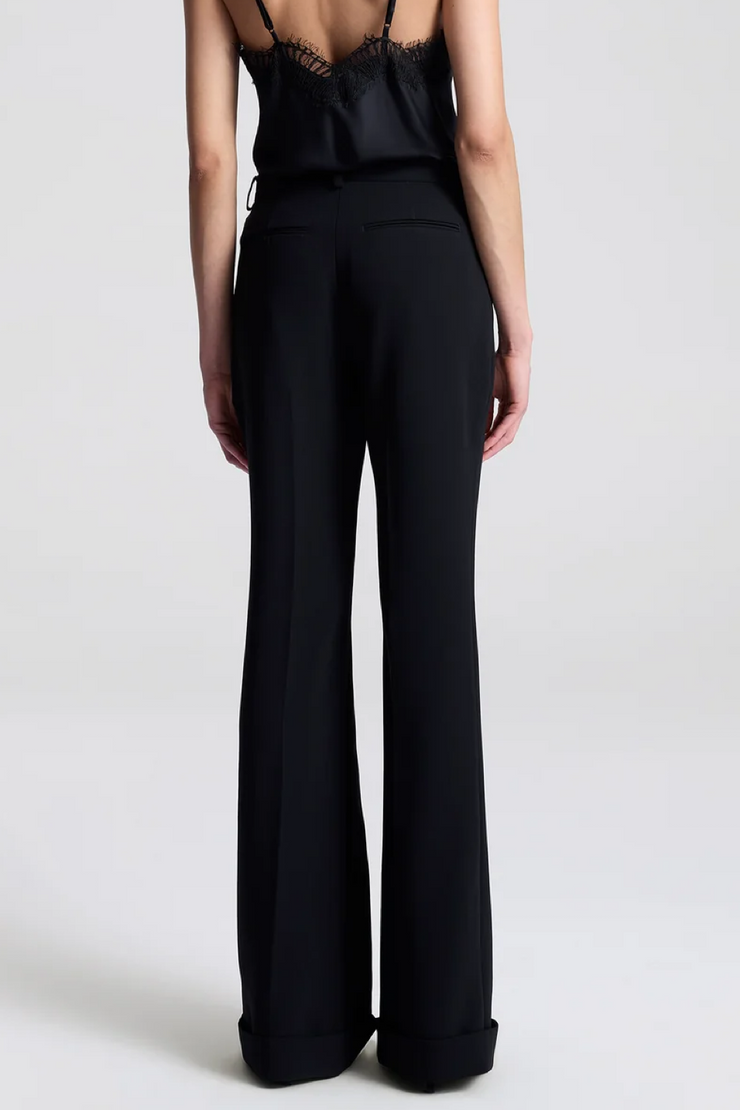 Person wearing a black jumpsuit on a white background