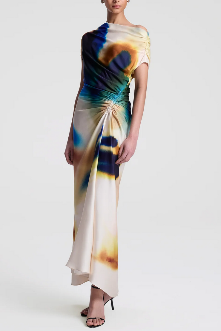 Woman wearing a colorful tie-dye dress on a white background