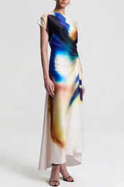 Woman wearing a colorful dress with abstract design on a white background