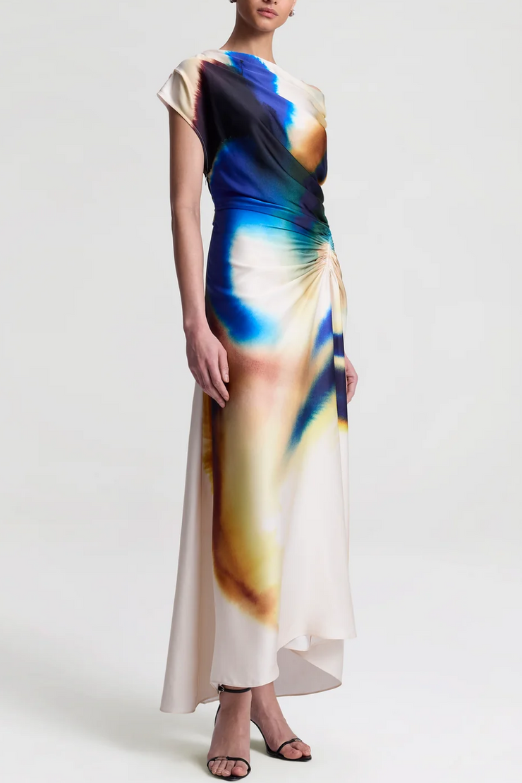 Woman wearing a colorful dress with abstract design on a white background