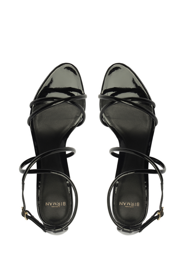 Black high-heeled sandals with strappy design on a white background