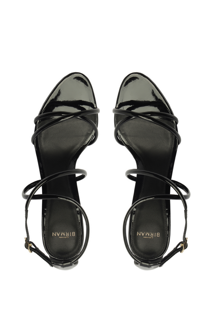 Black high-heeled sandals with strappy design on a white background