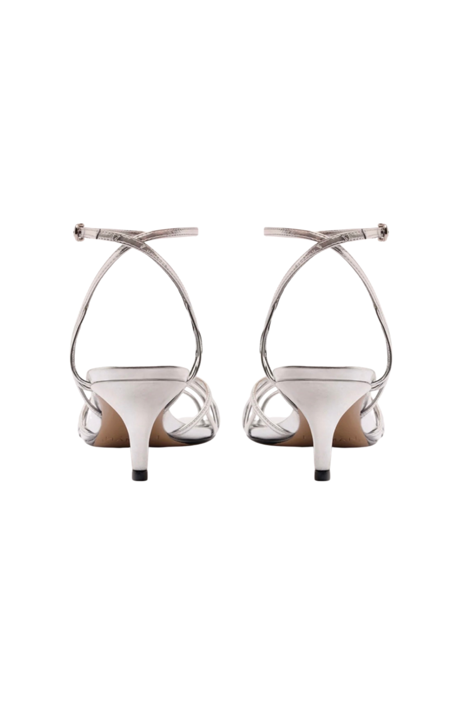 Pair of white high-heeled shoes with thin straps on a white background