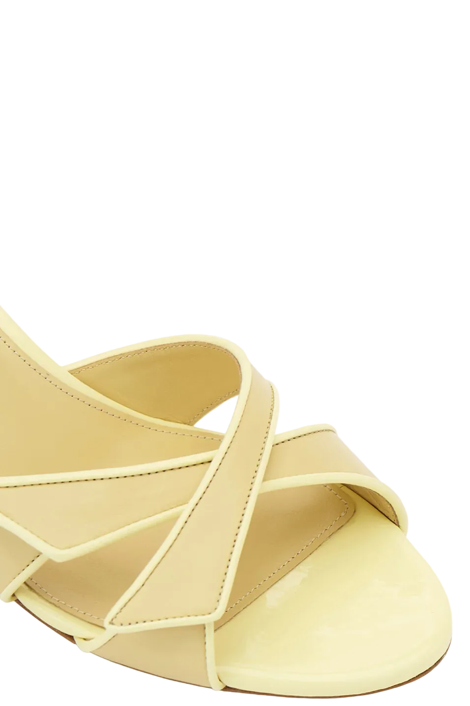 Light yellow sandal with criss-cross straps on a white background