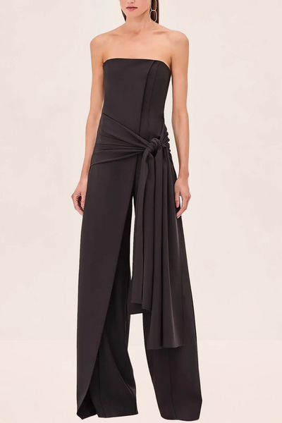 Black strapless jumpsuit on a beige background