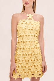 Yellow floral dress on a model against a light pink background
