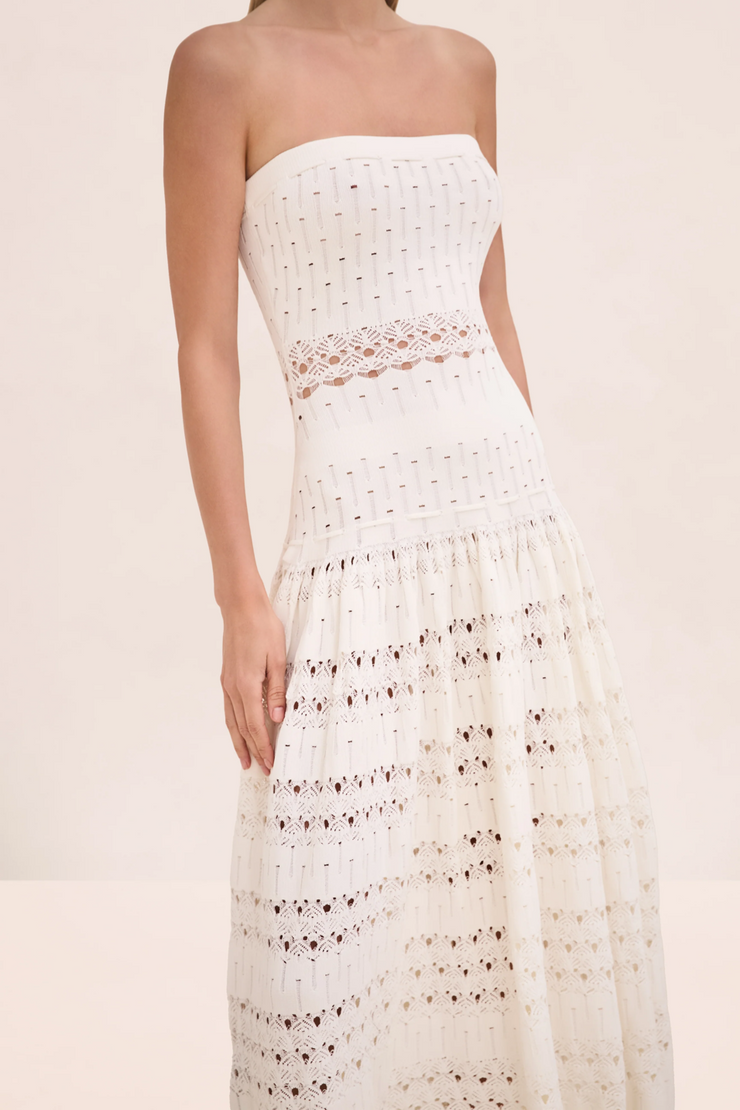 White strapless lace dress on a plain background
