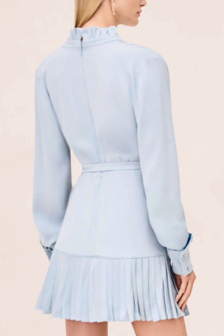 Light blue dress with pleated skirt on a plain background