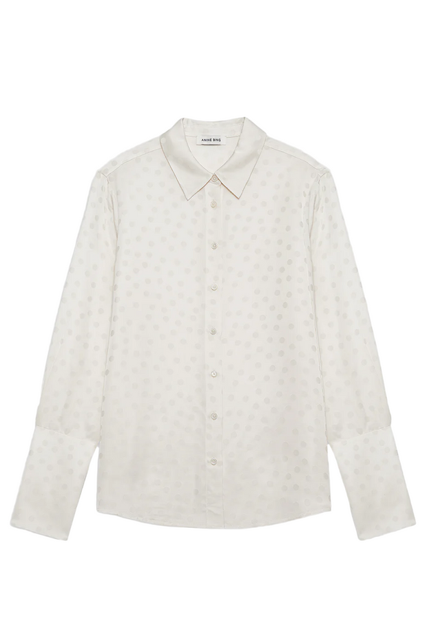 Ivory dot shirt on a light gray background