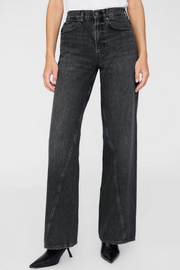 Black jeans worn by a person on a white background