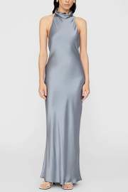 Woman wearing a gray halter neck gown on a white background