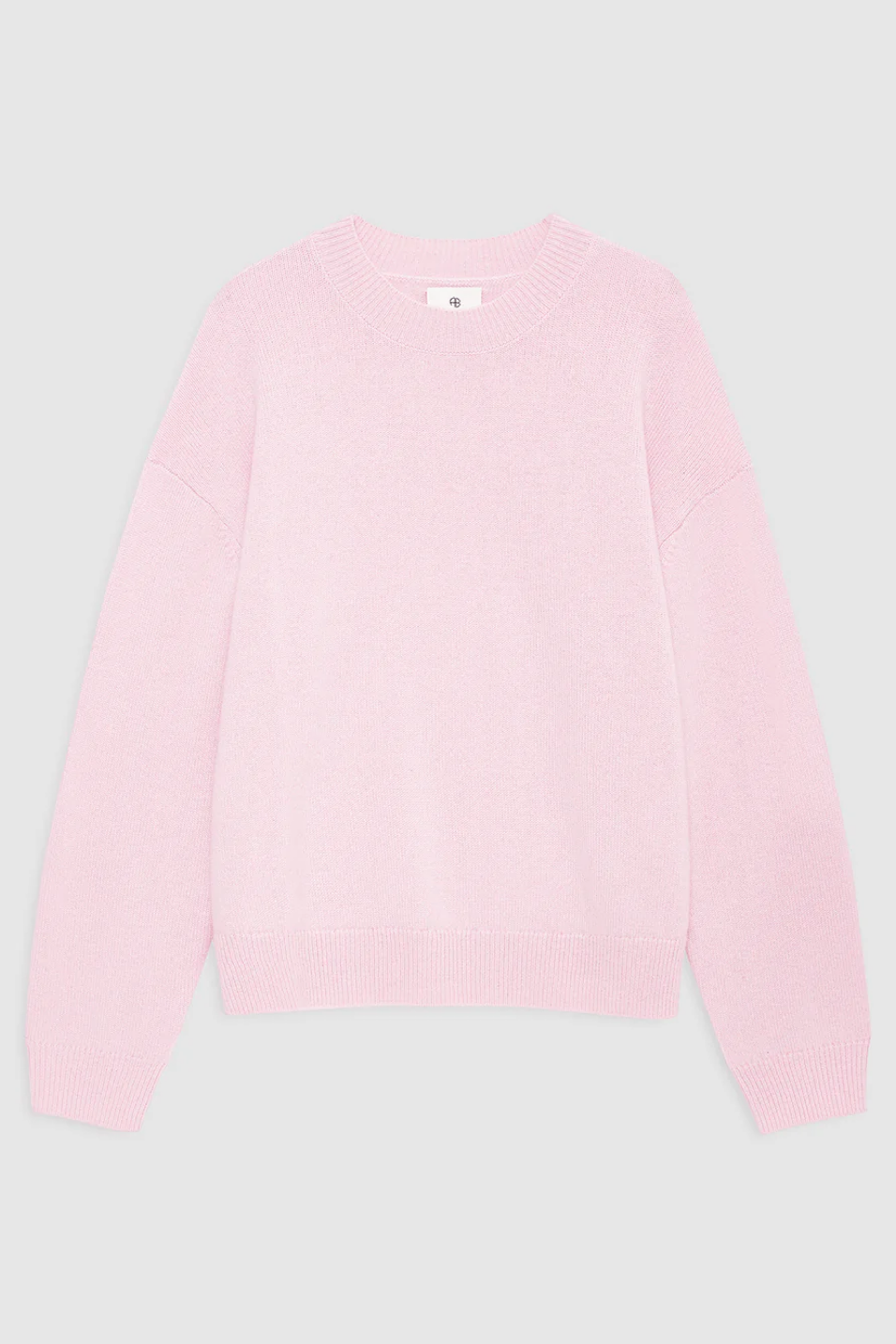 Pink sweater on a light gray background