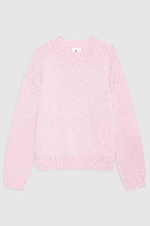 Pink sweater on a light gray background
