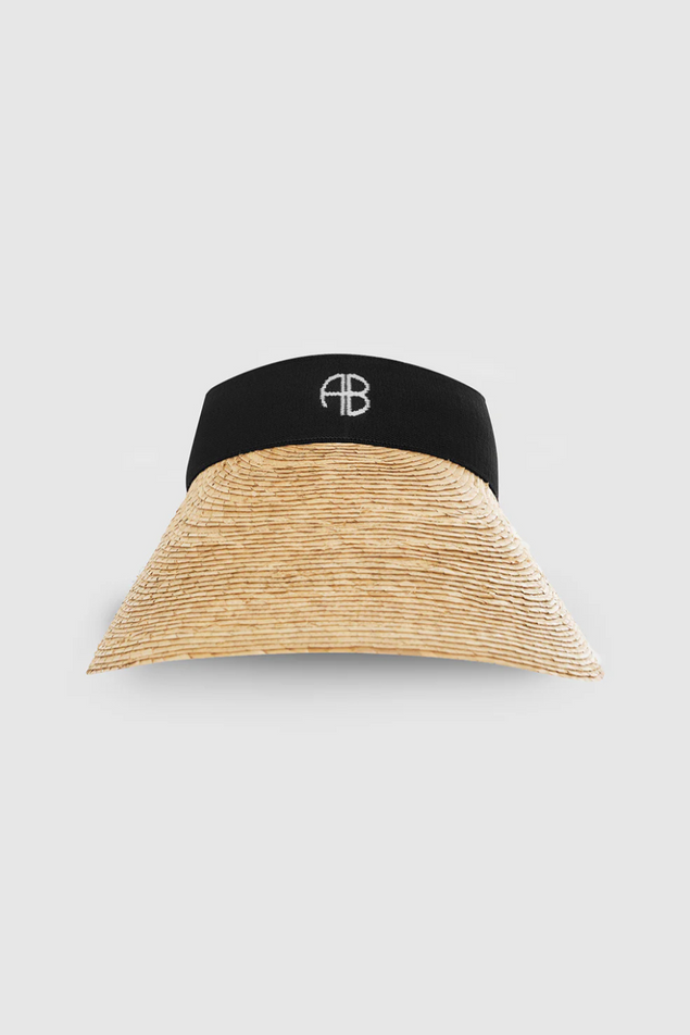 Black and beige visor hat on a light gray background