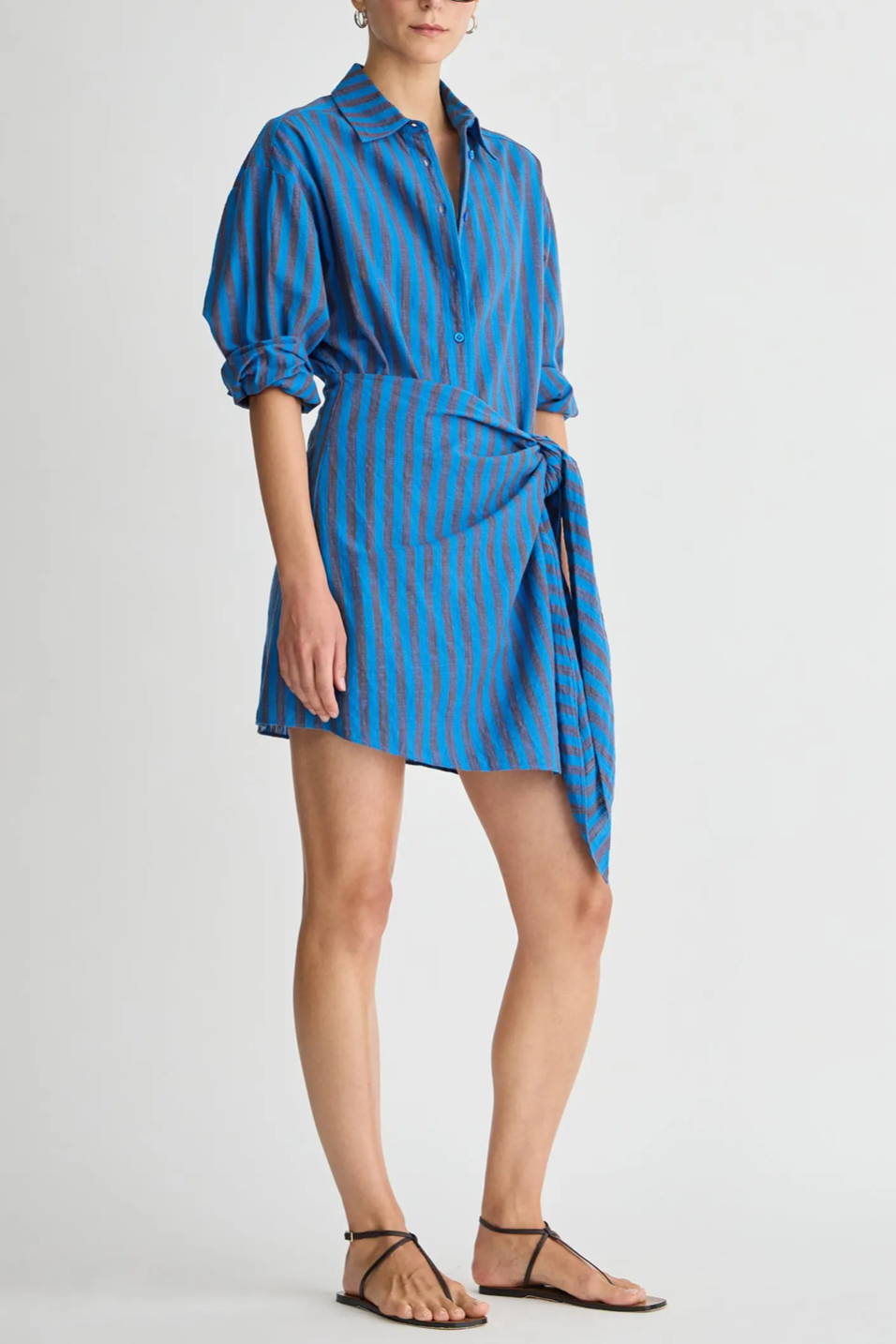 Woman wearing a blue striped dress on a white background