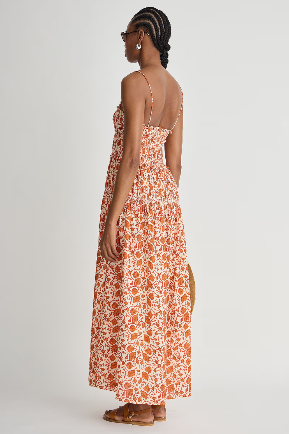 Woman wearing a floral dress with a white background
