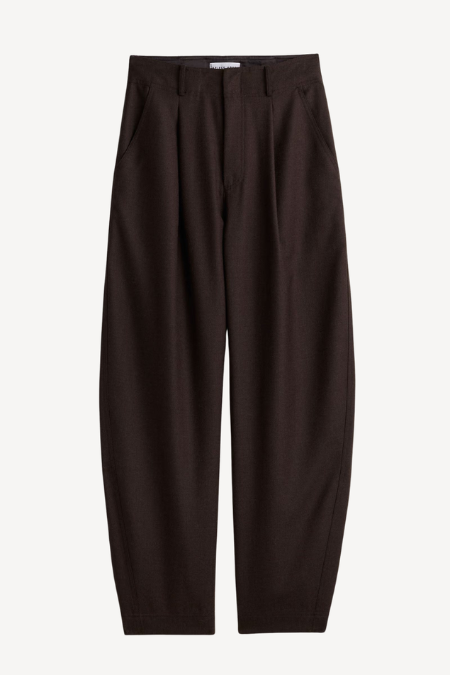 Dark brown wide-leg trousers with a relaxed, slightly baggy silhouette and front pleats, shown flat against a light gray background.