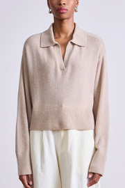 Beige sweater worn by a person on a white background