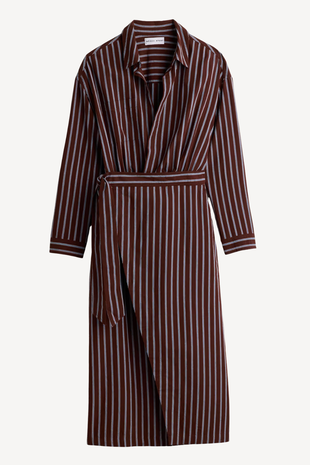 A long-sleeve wrap dress with vertical dark red and white stripes, featuring a collar, buttoned front, and self-tie belt, shown against a plain light gray background.