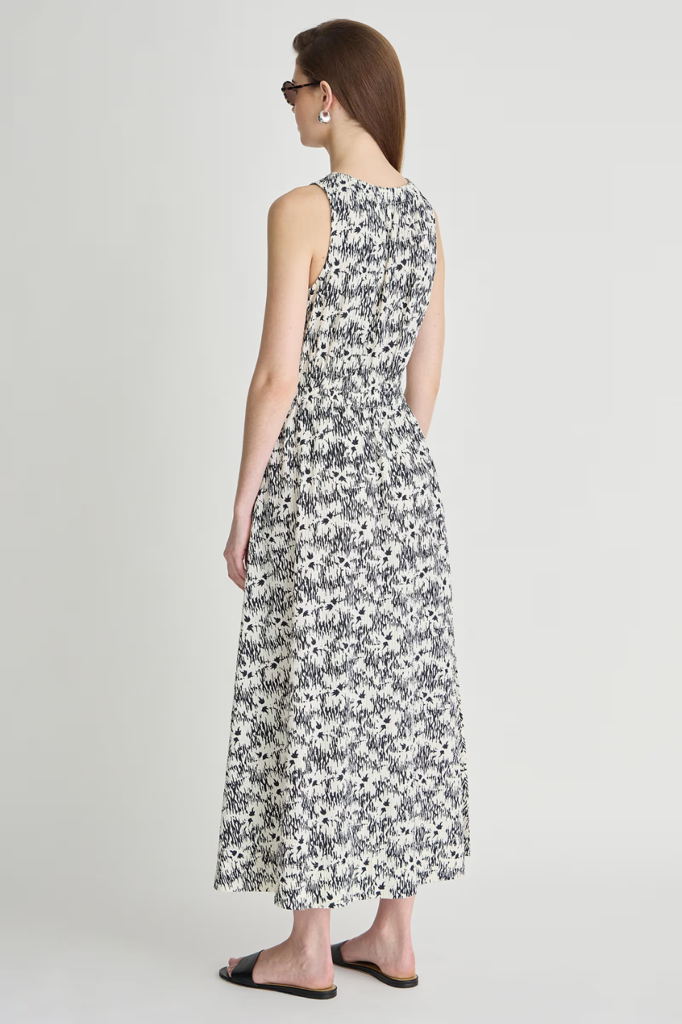 Woman wearing a floral dress on a plain background