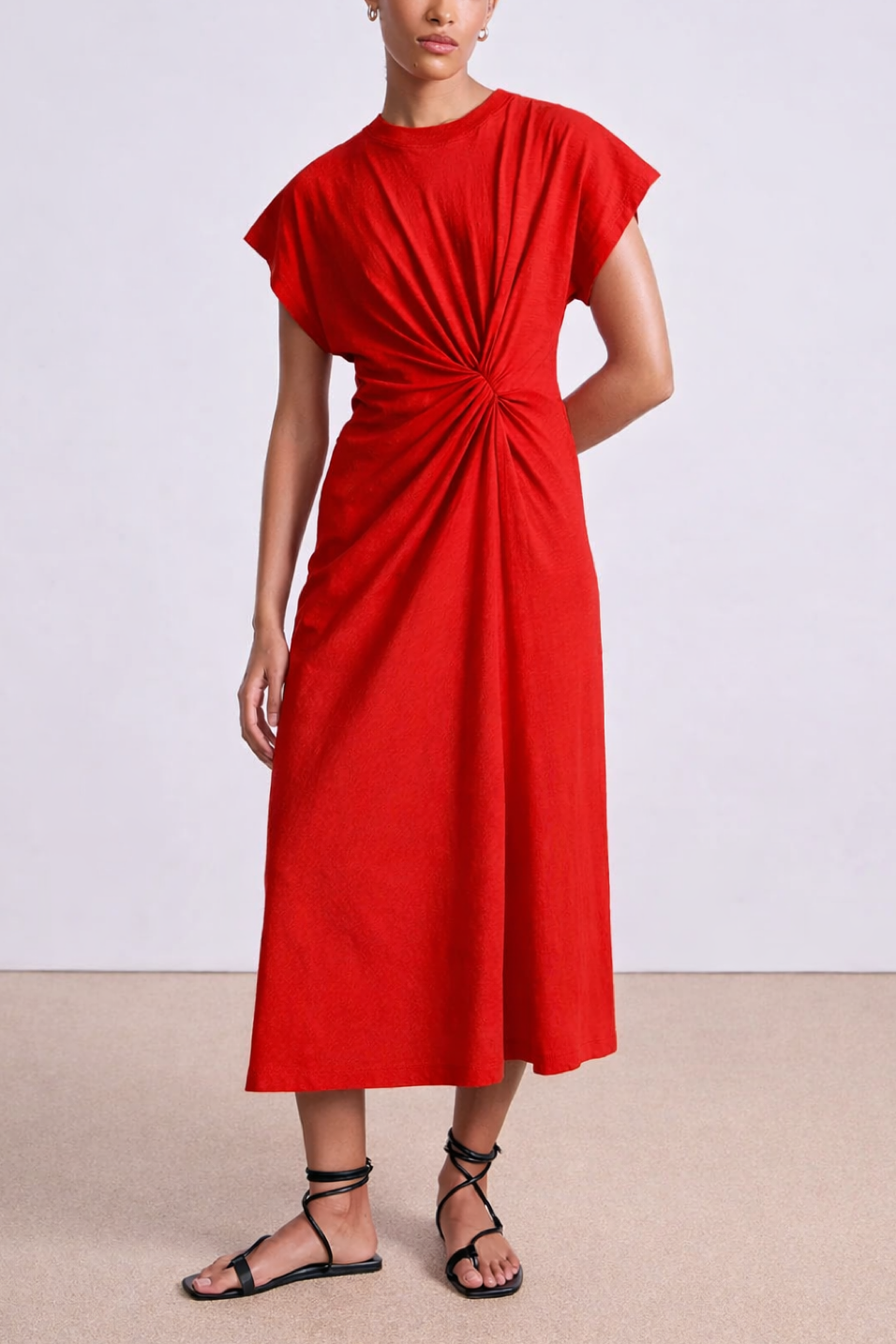 Red dress worn by a person on a plain background