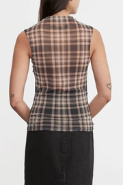 Person wearing a sleeveless plaid shirt with a plain background