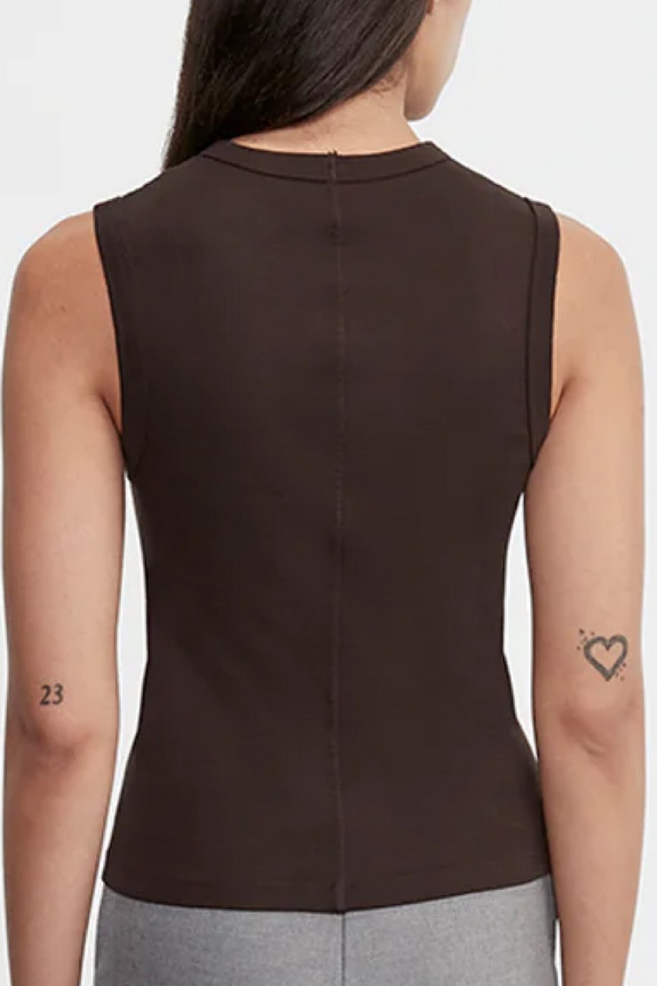 Brown sleeveless top worn by a person on a white background