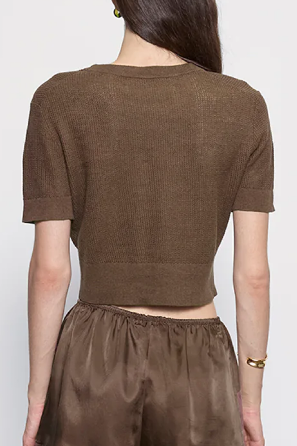 Brown short-sleeve top and pants worn by a person on a white background