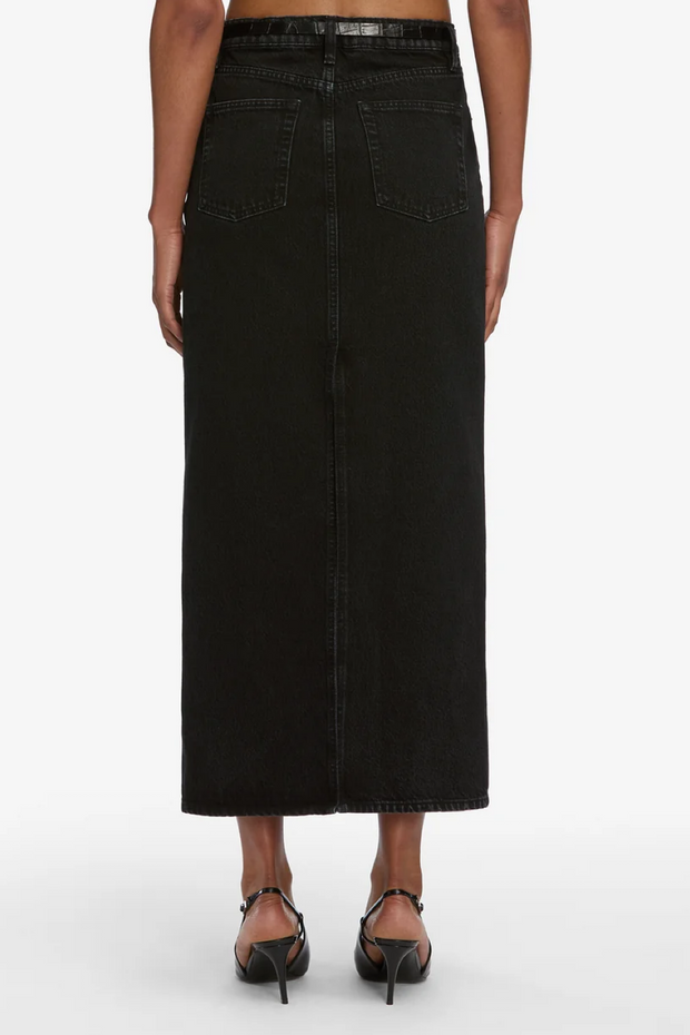 Black denim skirt worn by a person on a white background