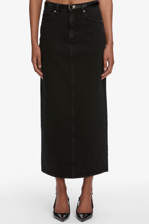Black denim skirt worn by a person on a white background