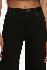 Black jeans worn by a person on a white background