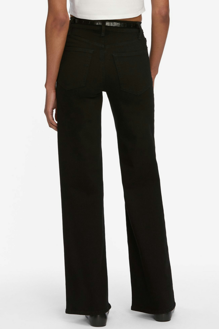 Black pants worn by a person on a white background