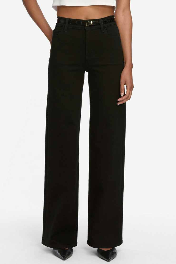 Black wide-leg jeans worn by a person on a white background
