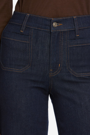 Close-up of dark blue jeans with a white background