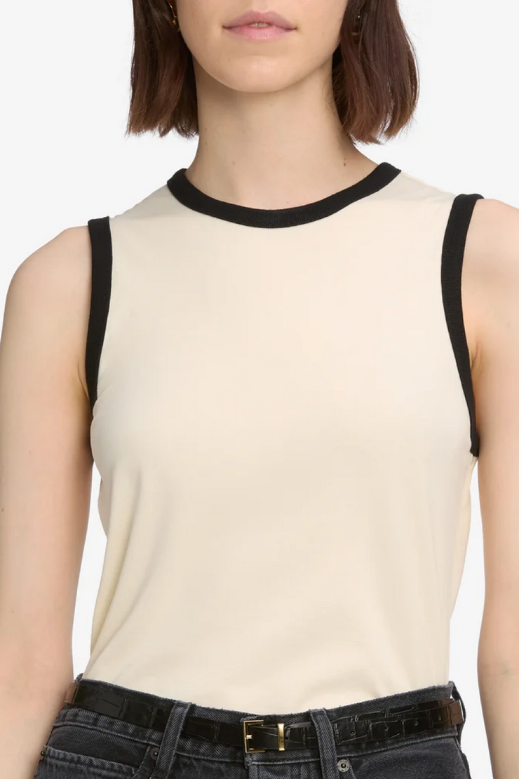 Cream sleeveless top with black trim worn by a person on a white background