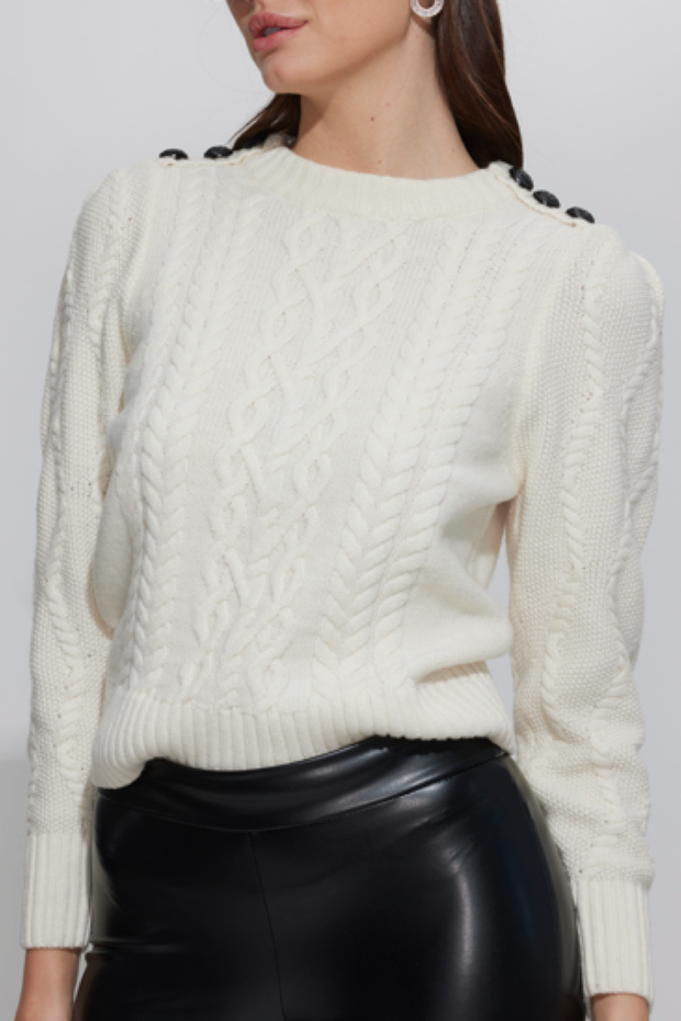 Image of model wearing Generation love Brooks cable sweater in cream with black buttons