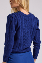 Image of model wearing Generation Love Brooks cable sweater in navy